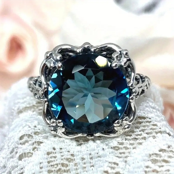 Boutique Jewelry - Intricate Silver Ring with Deep Blue Gem